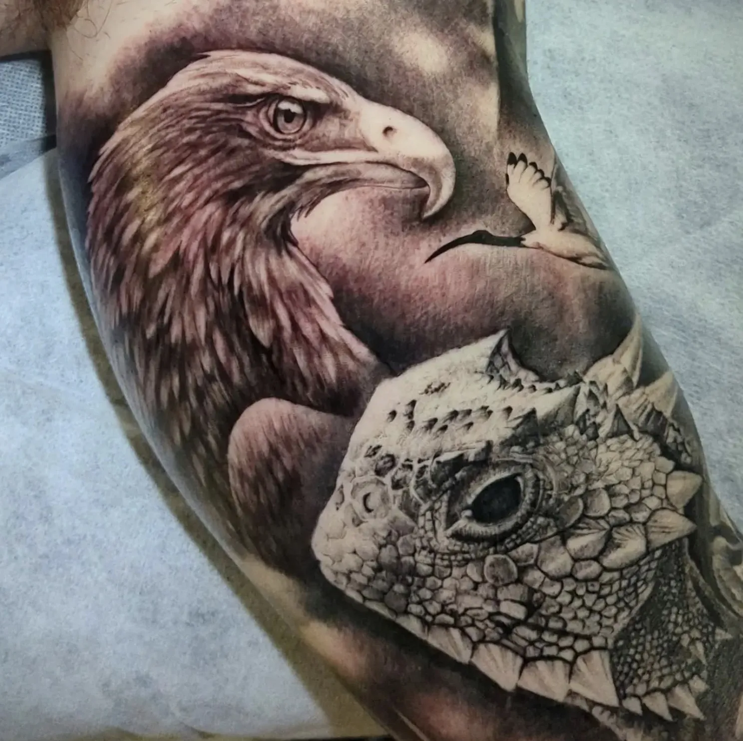 Detailed eagle portrait tattoo with intricate feather textures